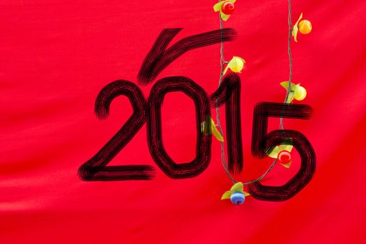 Chinese Calligraphy 2015 Year of the Goat 2015 on red silk fabric background