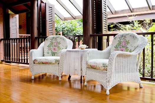 Outdoor rest area with white nice armchair sofa,