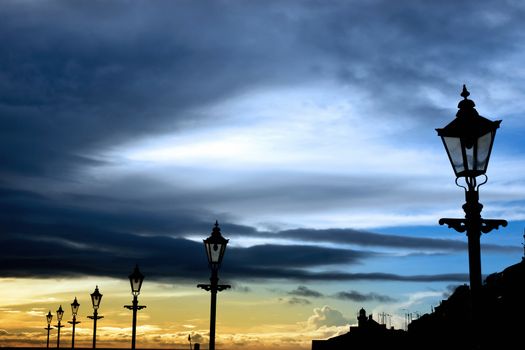 lighthouse and row of vintage lamps on the promenade in Youghal county Cork Ireland