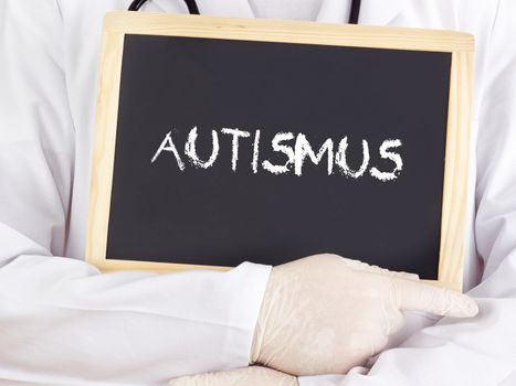 Doctor shows information on blackboard: autism in german