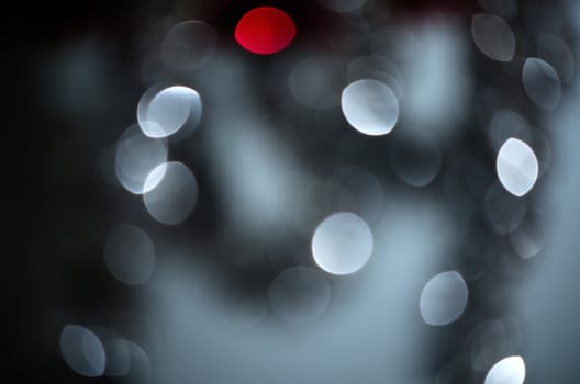 Red among silver circle blur lights, christmas background.