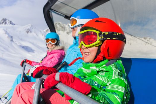 Skiing - happy skiers on ski lift