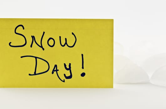 SNOW DAY written on yellow index card and placed in front of ice.
