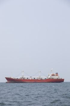 Large cargo ship Boats moored in the sea to make sense compared to the coast.