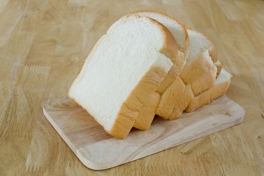 Slide bread on wooden cutting board