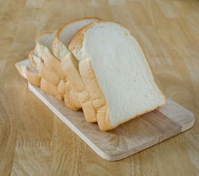 Slide bread on wooden cutting board