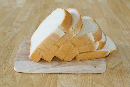 Slide bread on wooden cutting board