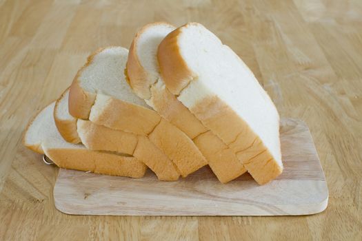 Slide bread on wooden cutting board