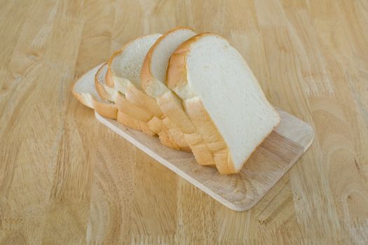 Slide bread on wooden cutting board