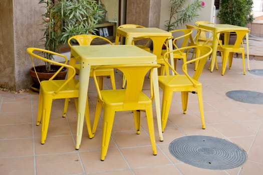 Yellow tables and chairs at outdoor restaurant