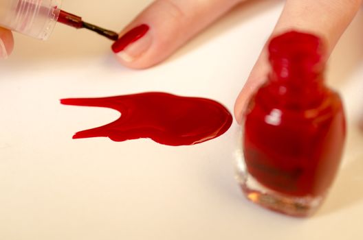 In beauty salon.Toes with red nail polish.