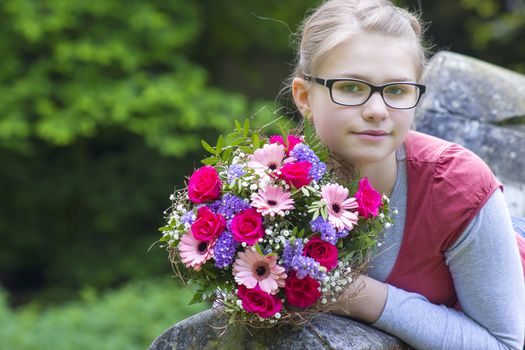 cute young girl with flowers - gift for the mother