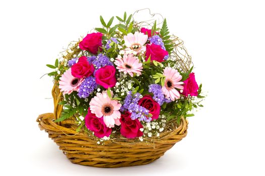 colourful flowers in a basket on white background