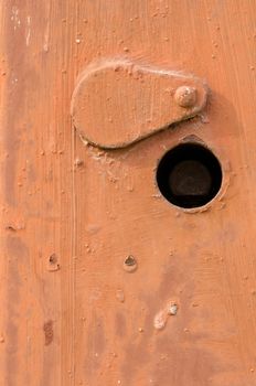 Orange rusty doors texture. Switchboard cover with keyhole.