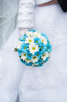 Wedding bouquet in hands of the bride.