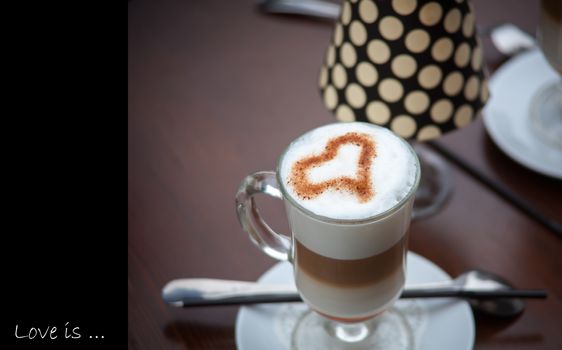 A Latte Coffee art on the wooden desk.