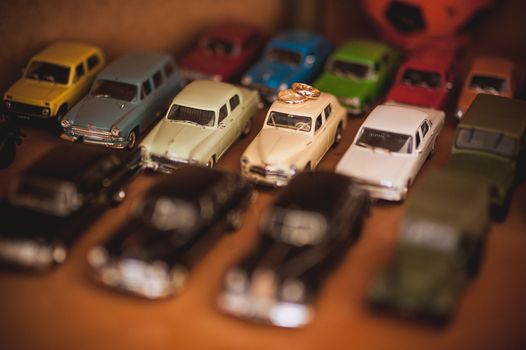 two gold wedding rings on top of toy car collection 