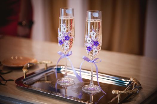 decorated with purple flowers and bow champagne glass 