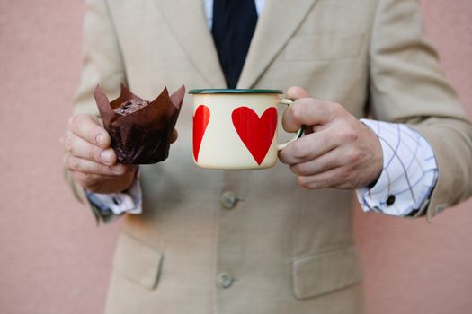 woman holding hot cup of coffee with heart