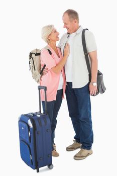 Smiling older couple going on their holidays on white background