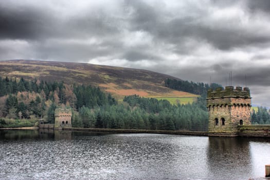 derwent reservoir dam breakwater under a cloudy sky