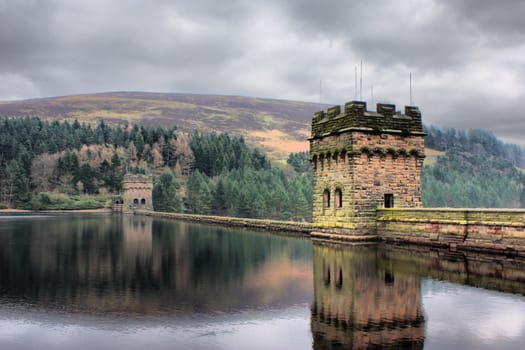 derwent reservoir dam breakwater under a cloudy sky