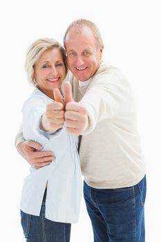 Happy mature couple showing thumbs up on white background
