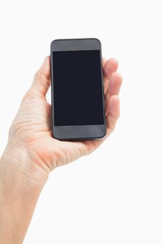 Woman showing black smartphone screen on white background