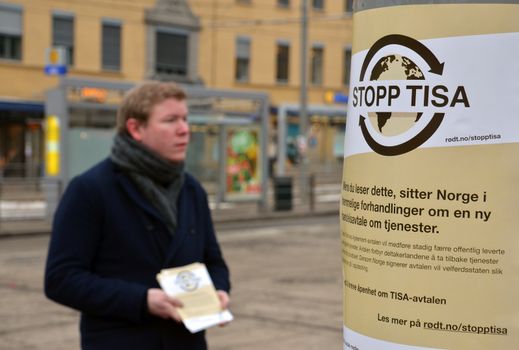 A young man handing out leaflets against the Trade in Services Agreement (TISA) in central Oslo. The agreement aims at liberalizing the worldwide trade of services such as banking and transport. Criticism about the secrecy of the agreement arose after WikiLeaks released in June 2014 a classified draft of the proposal's financial services annex.