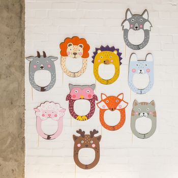 Set of cardboard masks on a white brick wall. Consept card.