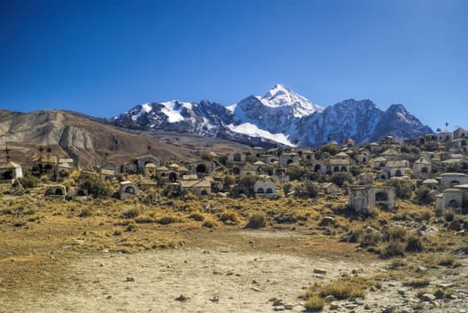 Graveyard with Huayna Potosi mountain in the background, peak in Bolivian Andes