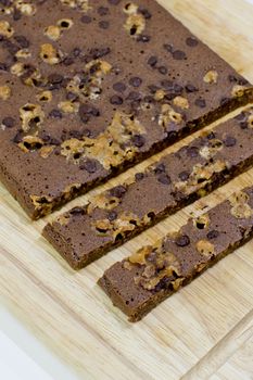 Cutting homemade brownies on wooden background