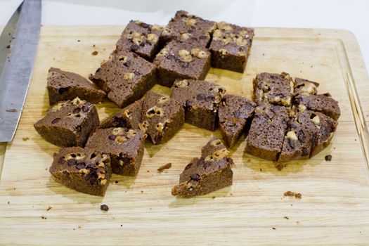 cubes homemade brownies on wooden background