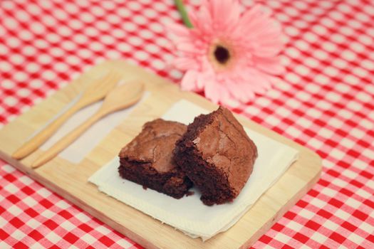Tasty brownies with wooden spoon and fork, retro filter effect 