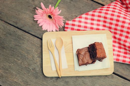 Tasty brownies with wooden spoon and fork, retro filter effect 