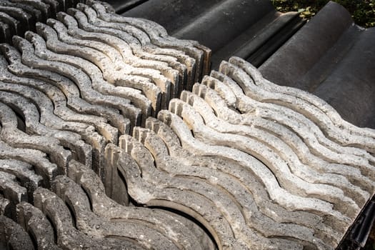 Roof tiles stacked needly to be used in new building project.