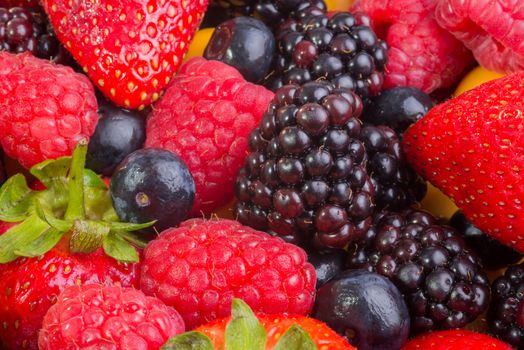 Up Close view of fresh berries of different types, all mixed together.