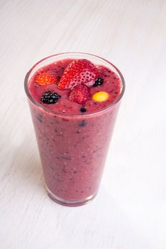 A smoothy made from different types of fresh berries.