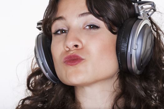 young woman listening to music in headphones