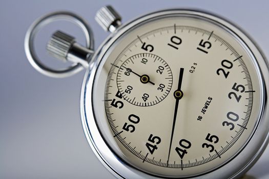 close-up of a stopwatch isolated on gray background