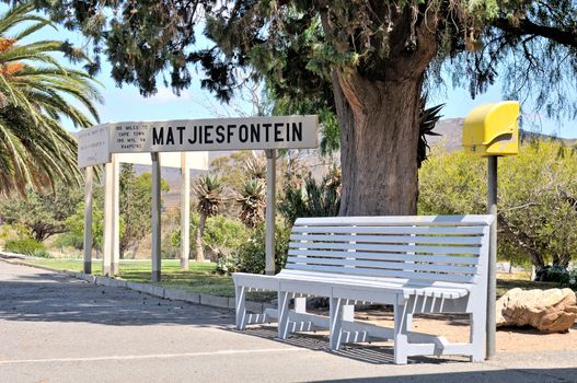 Bench and sign at the historical Matjiesfontein station in the Western Cape Province of South Africa

