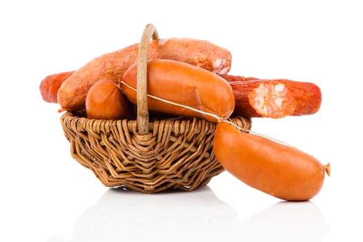 Smoked sausage on a string in basket. Isolated on white background