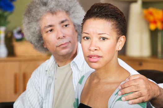 Concerned young woman with caring mature husband