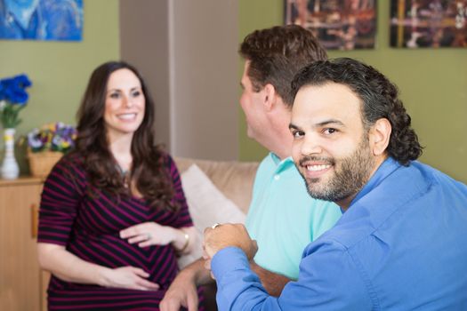 Smiling gay man and partner with surrogate mother