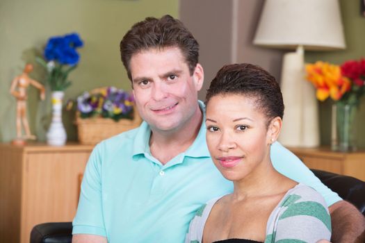 Attractive smiling male and female couple sitting together