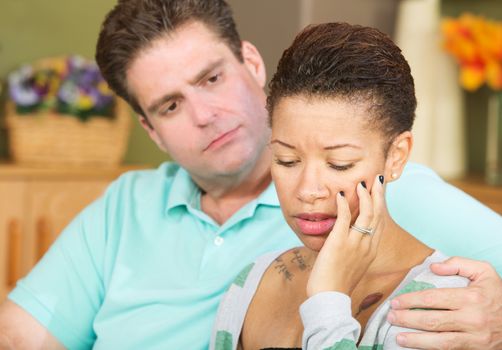 Anxious beautiful young spouse with concerned husband