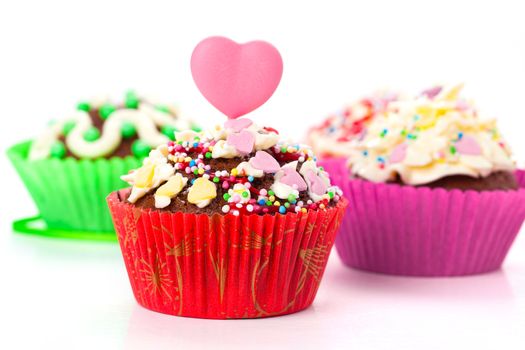 cupcakes with cream frosting and a red heart