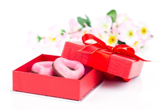 pink heart cookies for valentines day in red gift, on white background