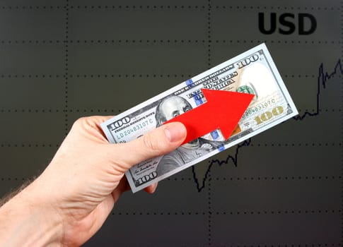 Red Arrow in a Hand with the Dollars on the Diagram Background