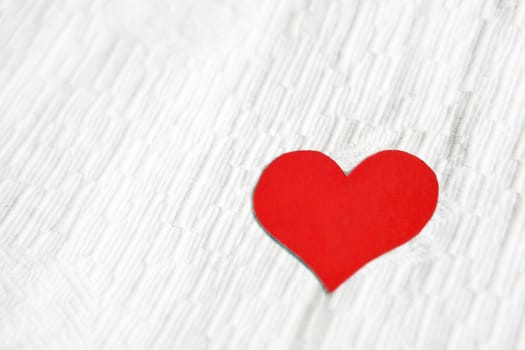 Red Heart Shape on the White Fabric Background
